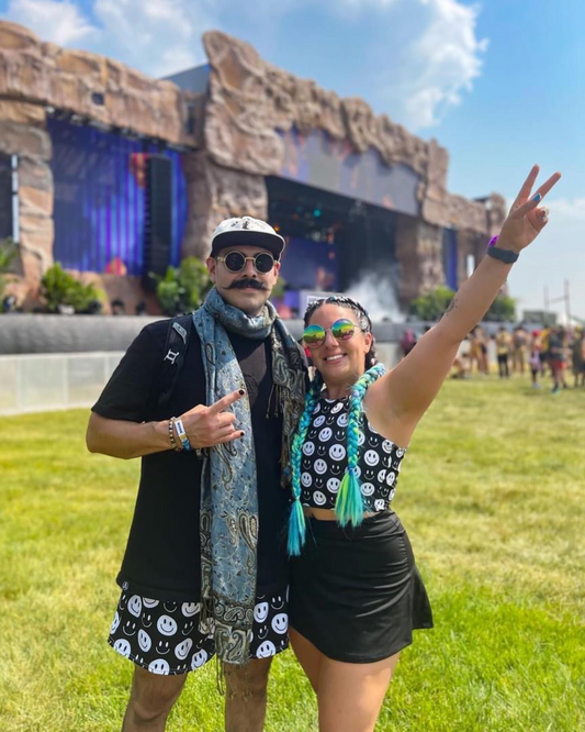 Couple wearing matching festival outfit from Bassline Movement while raving at Electric Forest music festival